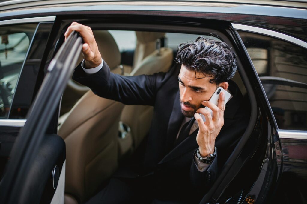 A Man in a Phone Call Getting out of a Car - Antalya airport transfers