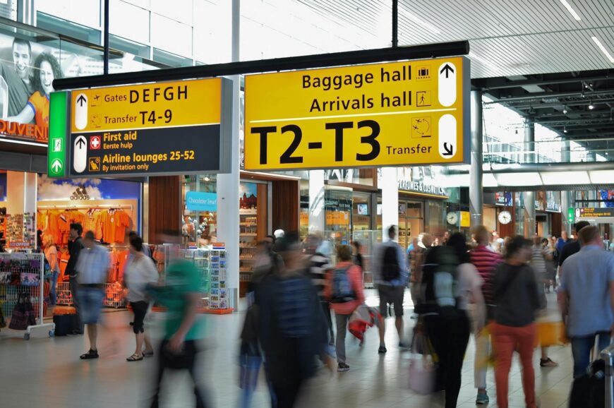 People Walking Beside Baggage Hall and Arrivals Hall Signage - Antalya airport transfers